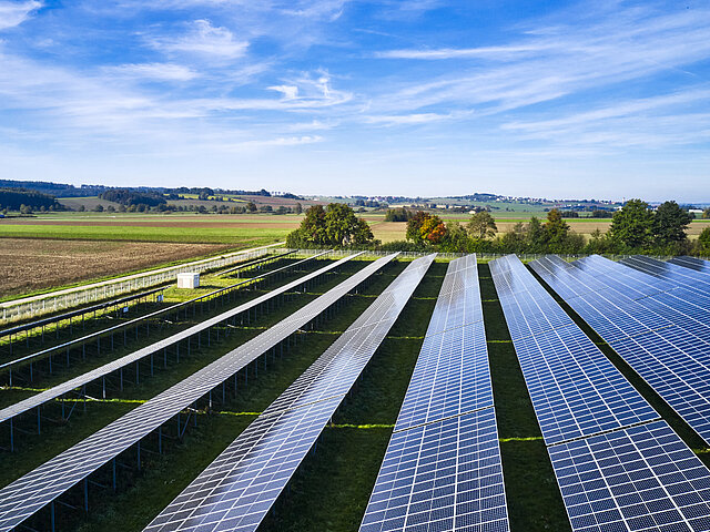Solar park photographed from the side from above in good weather.