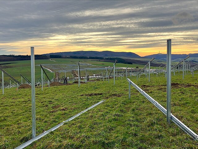 The frames needed for the solar panels in a green field.